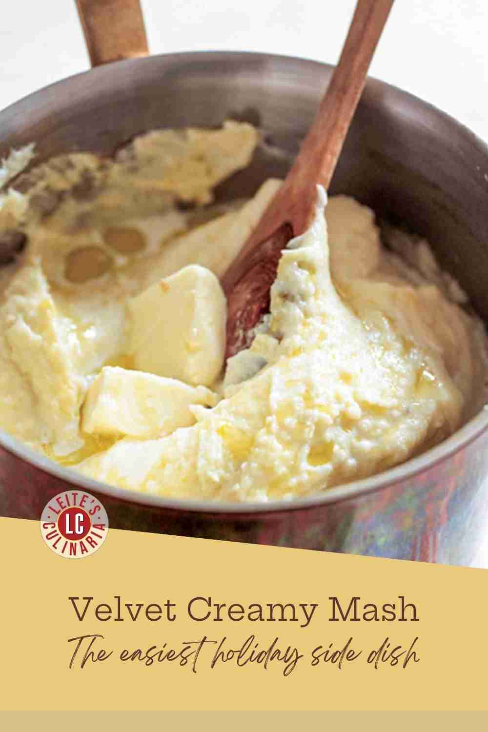 A pot of incredibly creamy, smooth mashed Yukon Gold potatoes topped with a melting pat of butter.