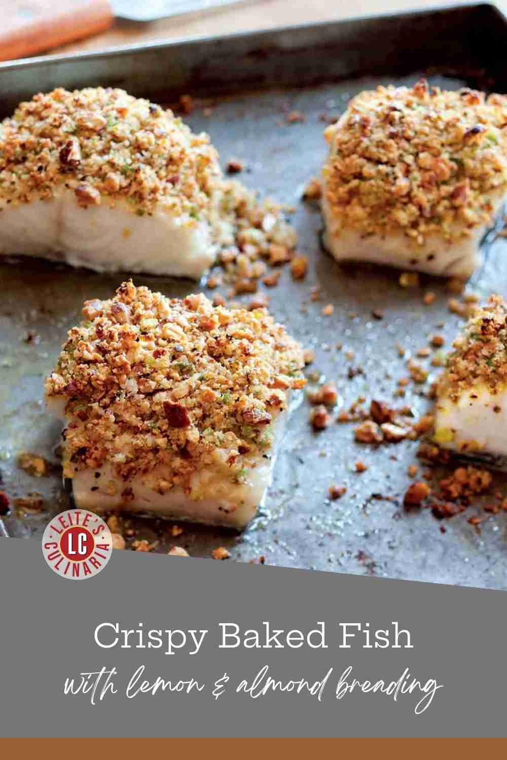 Four fish fillets on a baking sheet topped with a thick, golden-brown almond and herb breading.