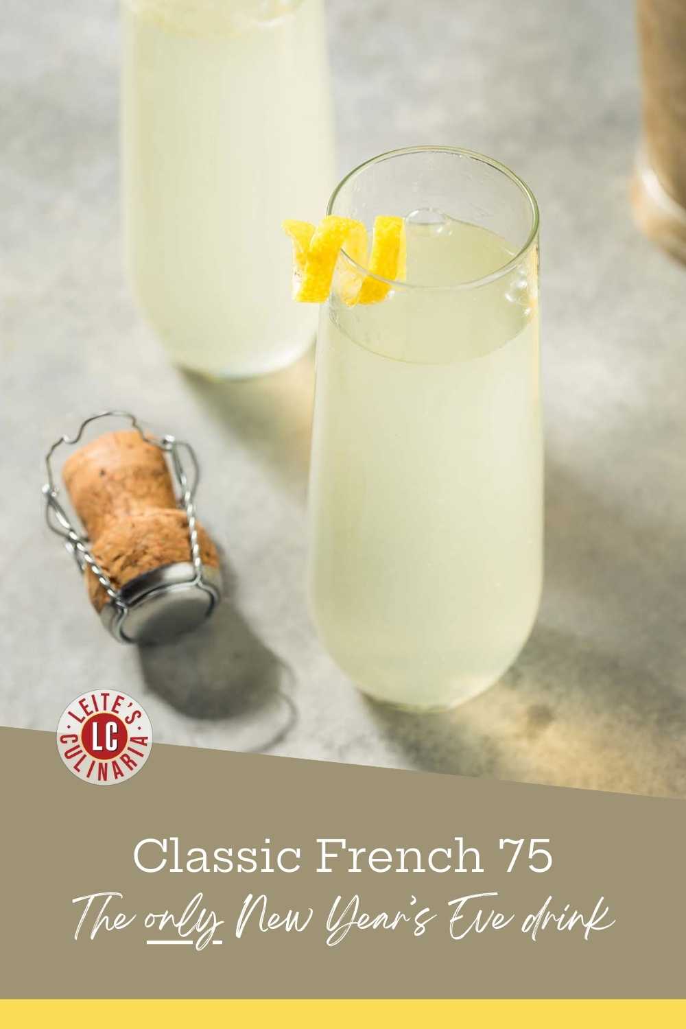 Two stemless champagne flutes filled with a classic French 75 cocktail made with gin and lemon juice, garnished with lemon twists, sitting next to a champagne cork.