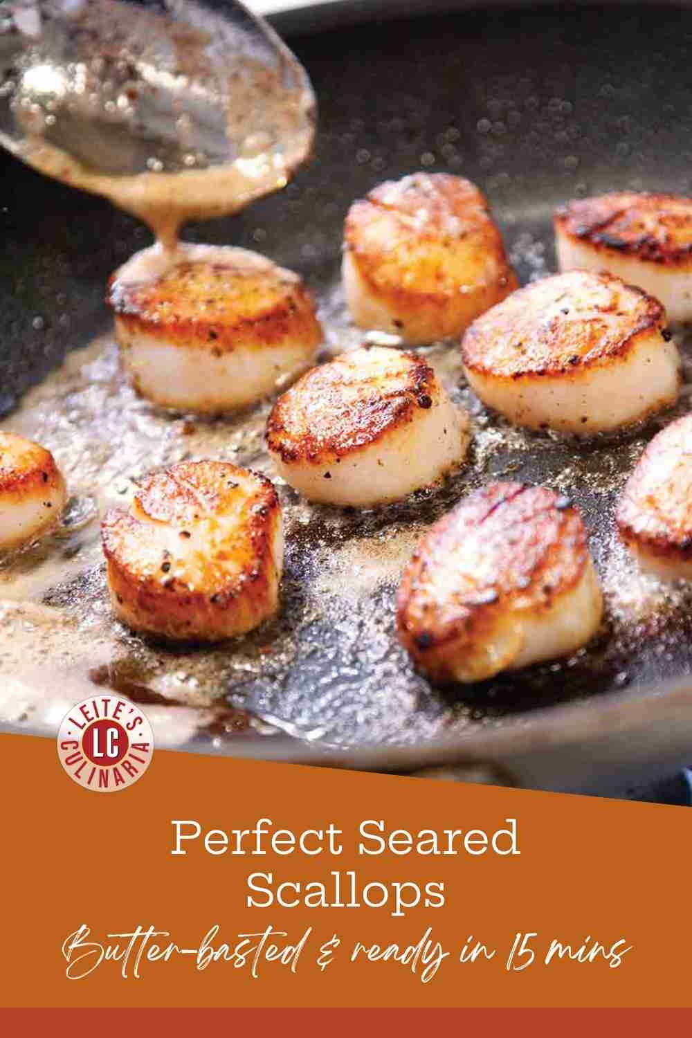 Golden brown sea scallops searing in a hot cast iron skillet being basted with melted foaming butter using a large spoon.