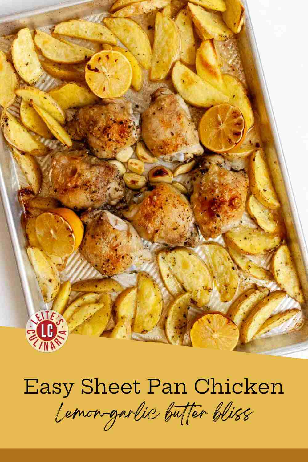 Golden roasted chicken thighs and potato wedges on a white platter with fresh parsley and lemon.