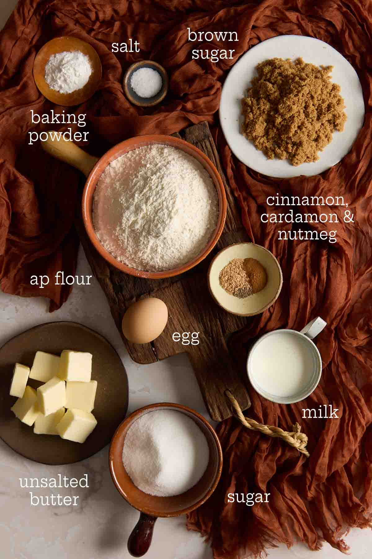 Flatlay of labeled ingredients including flour, butter, milk, egg, and spices for dirt bombs.