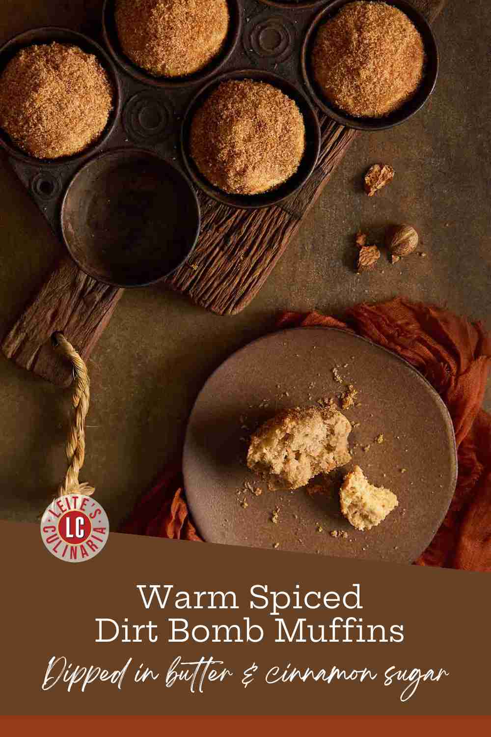 A dirt bomb, a cinnamon-cardamom-spiced muffin, on a brown plate with a cutting board with four more muffins.