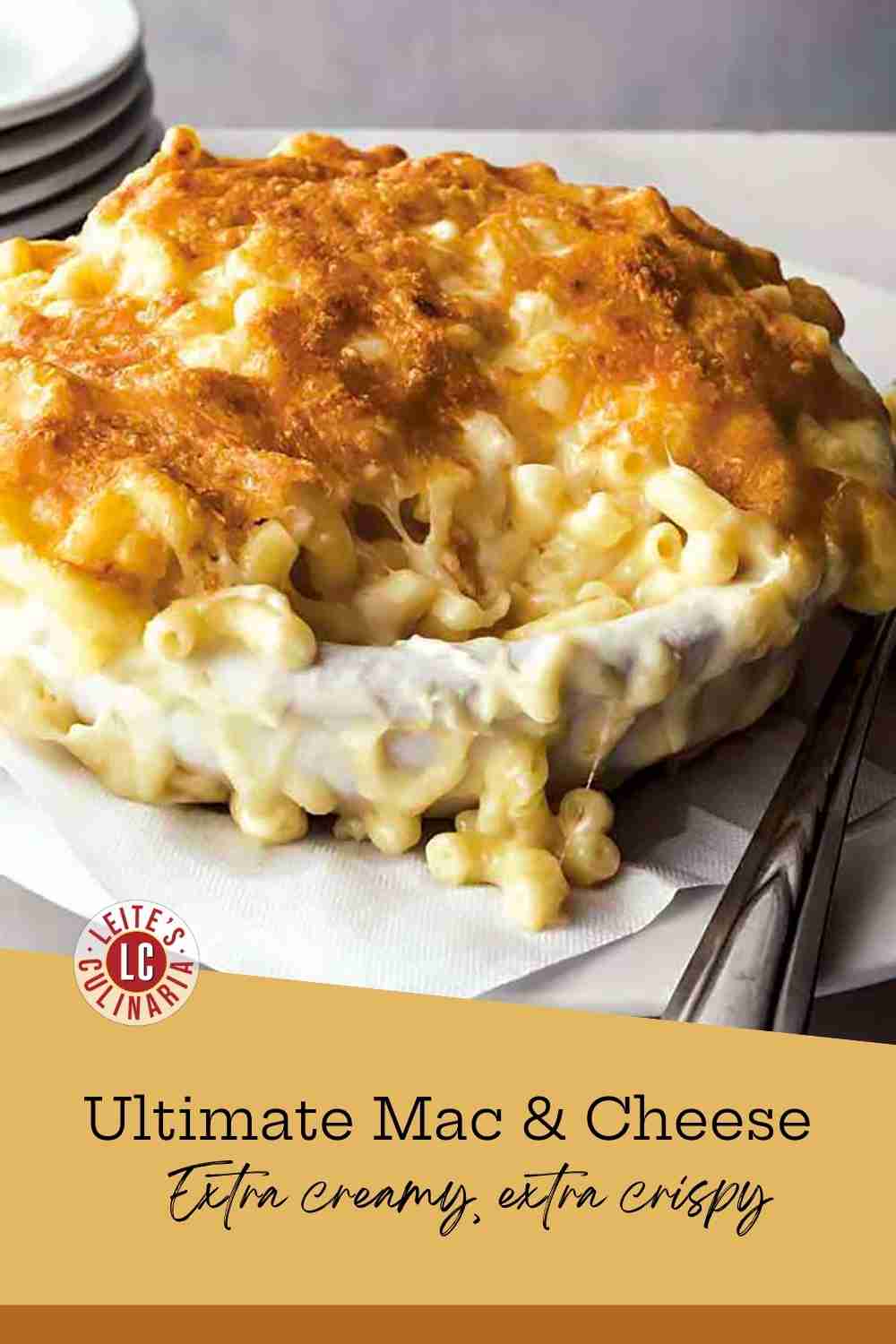 Bubbling creamy macaroni with a thick golden-brown cheese crust being served.