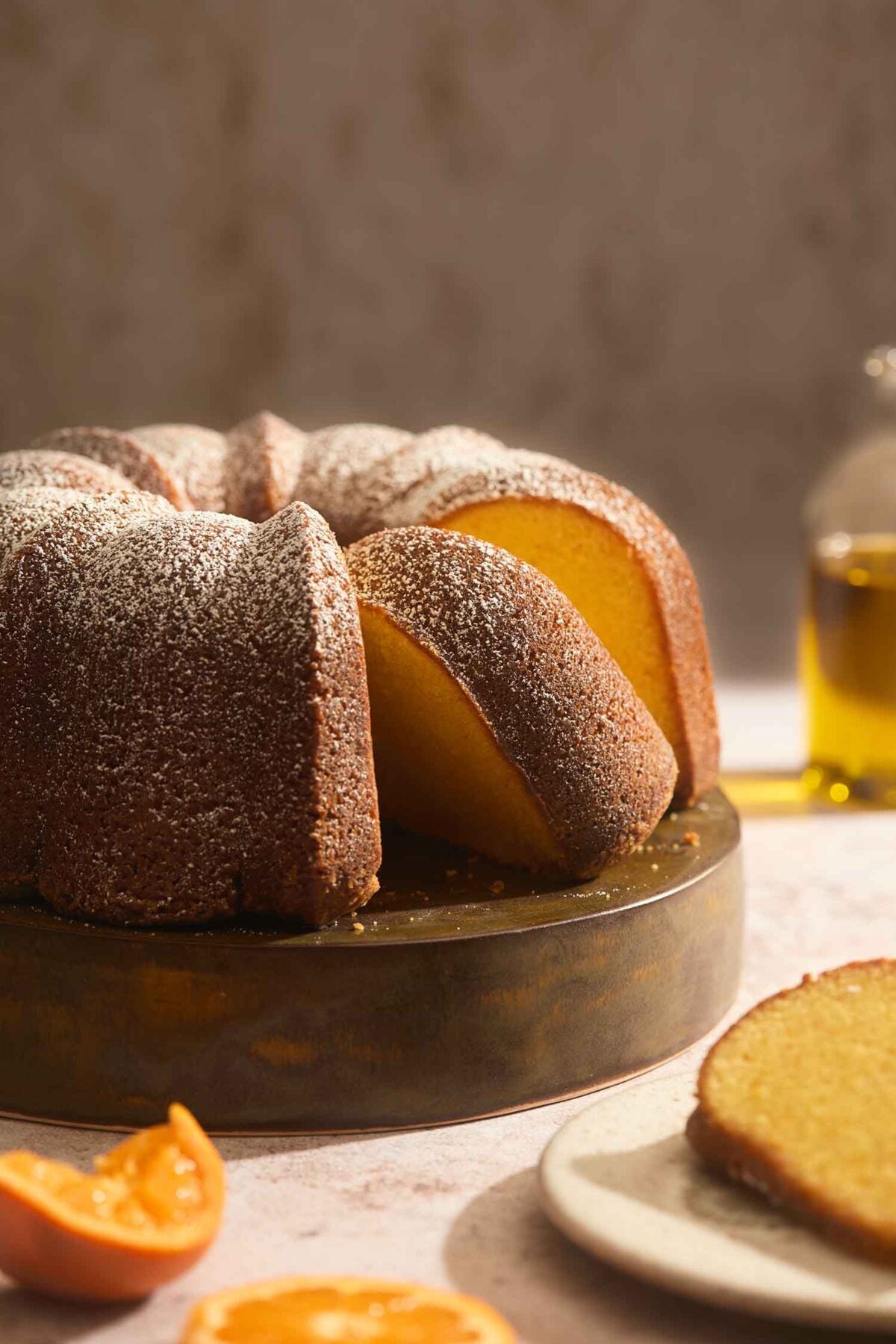 A single slice of moist orange olive oil cake showing the dense, tender interior crumb.