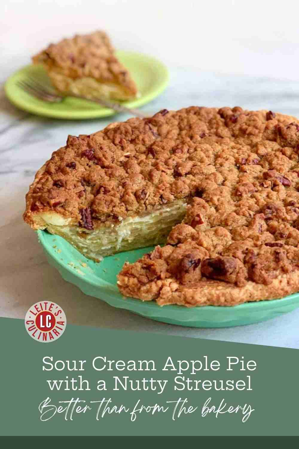 A pecan-streusel apple pie in a jadeite dish with one slice cut, a served slice on a green plate behind.