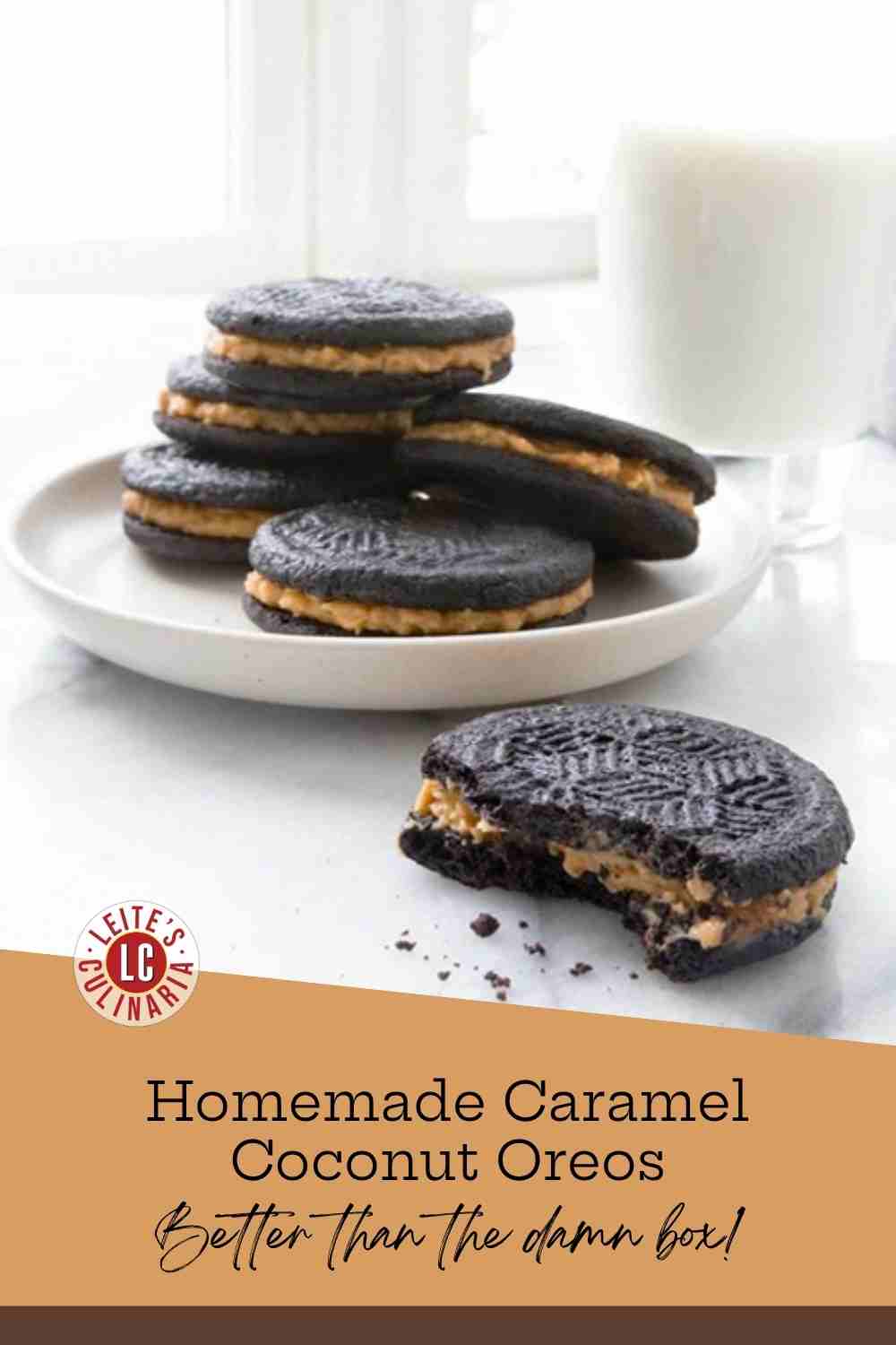 A stack of homemade caramel coconut Oreos with black cocoa wafers and butterscotch-coconut filling on a white plate beside a glass of milk, one cookie with a bite taken out.