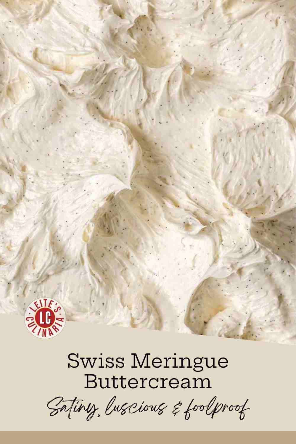 A bowl of glossy Swiss meringue buttercream swirled into soft peaks and speckled with vanilla seeds.