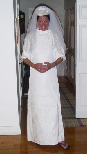 Deborah wearing her daughter's wedding dress and flip flops one 4th of July.